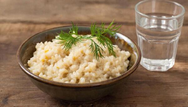 Порция вареной перловой каши на воде в тарелке для расчета калорий